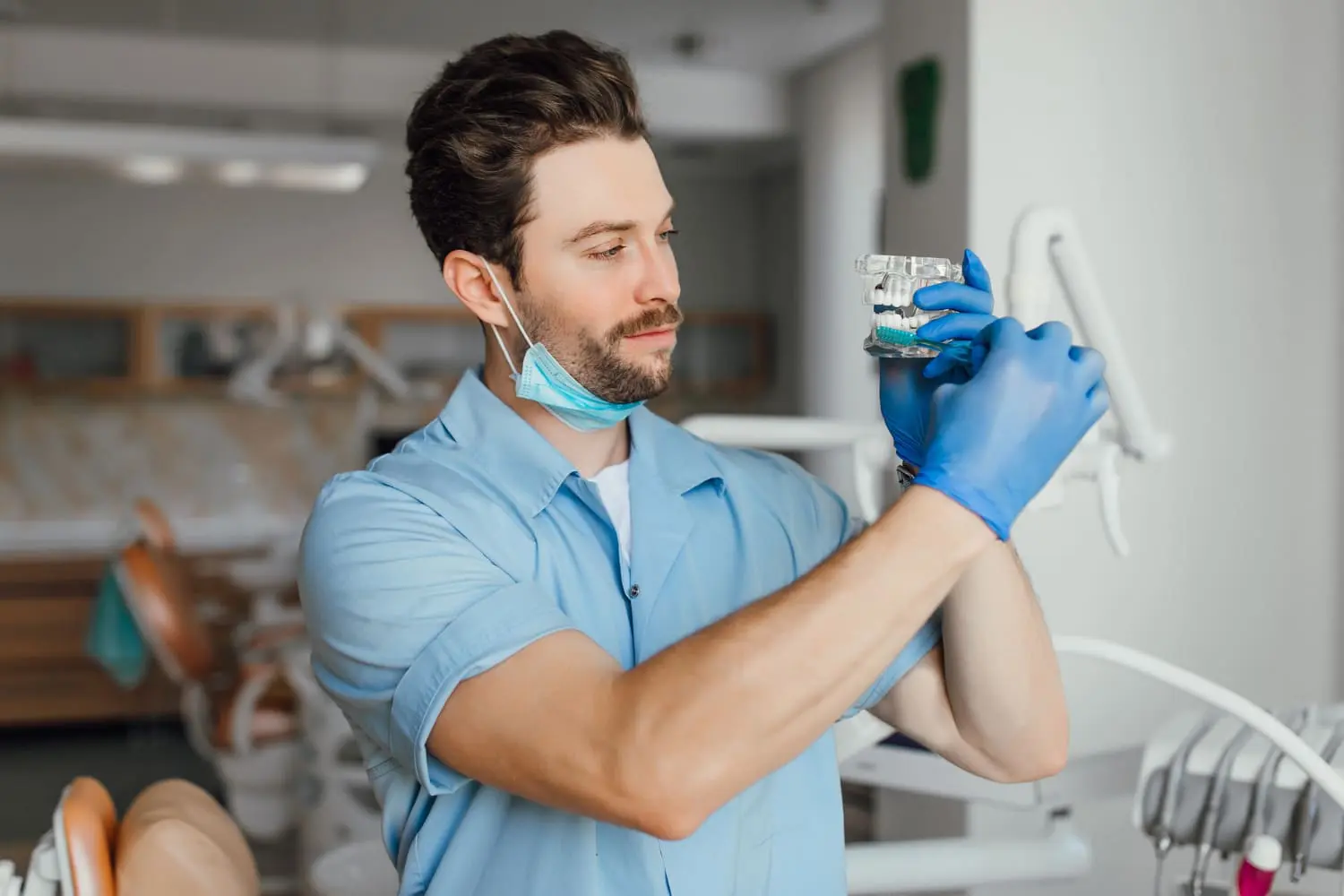 Orthodontist holding braces figure, straightening teeth effectively during an orthodontic treatment journey