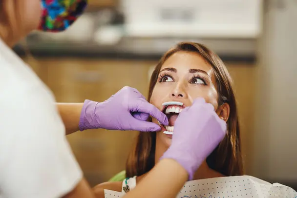 Teenager smiling while getting a consultation for lingual braces in Austin